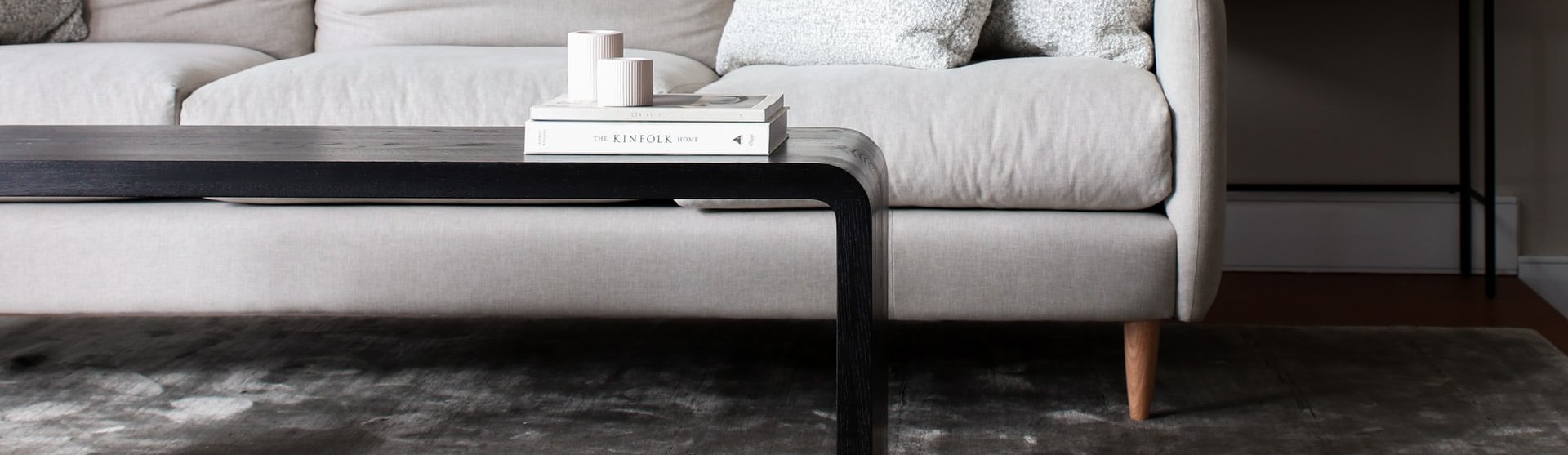 white couch and black coffee table on a brown hardwood floor from Bisbee's Flooring Center in Prairie, WI