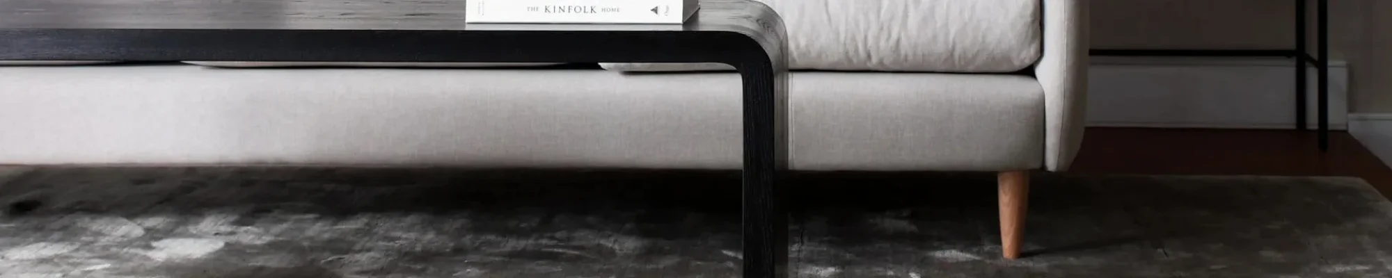 white couch and black coffee table on a brown hardwood floor from Bisbee's Flooring Center in Prairie, WI